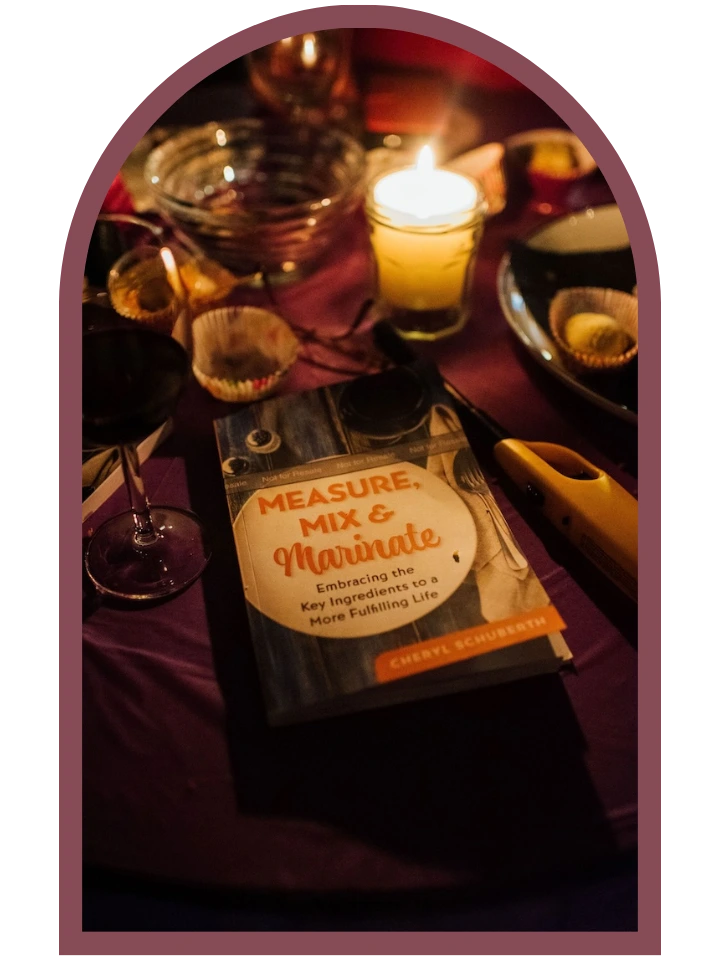table with candle, book, wine glass and dishes