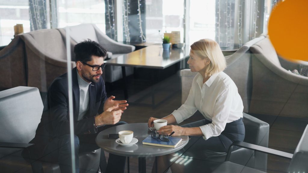 Leader demonstrating white space in leadership by making time for an unplanned discussion over coffee.