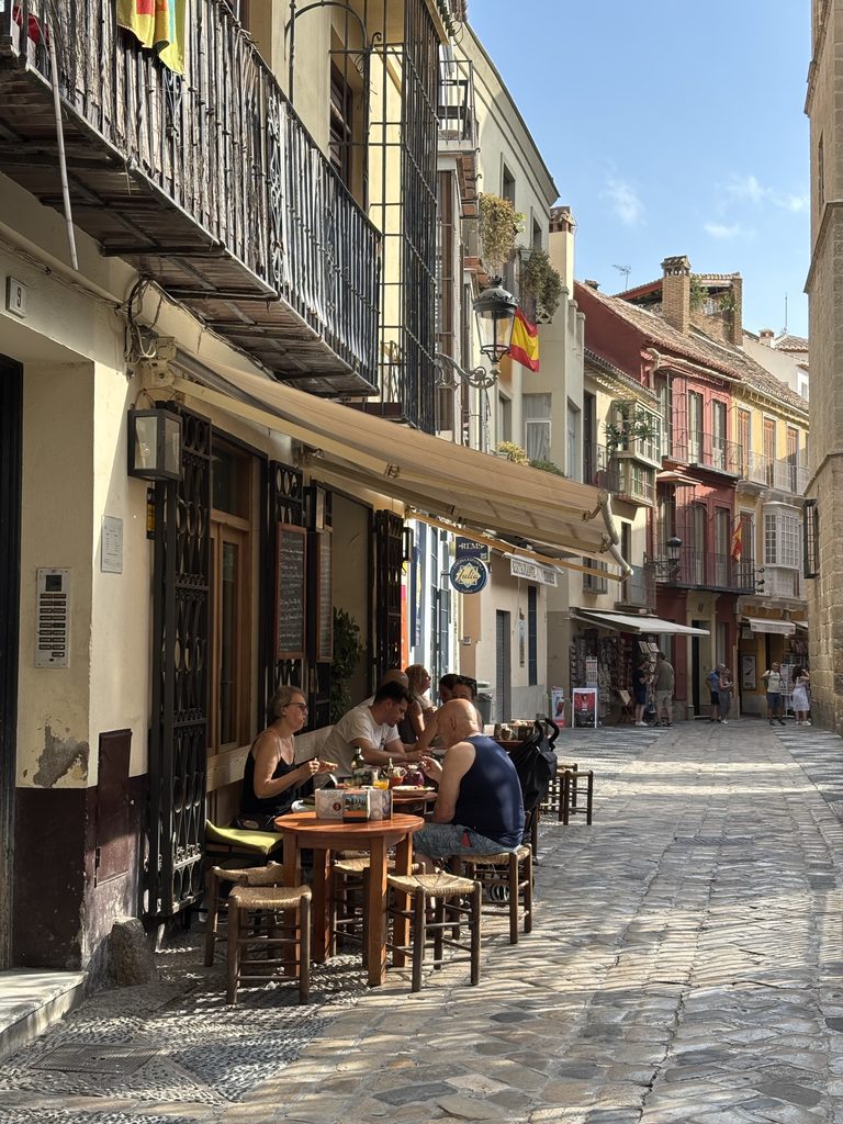 People eating outside a cafe in Europe while working abroad remotely.